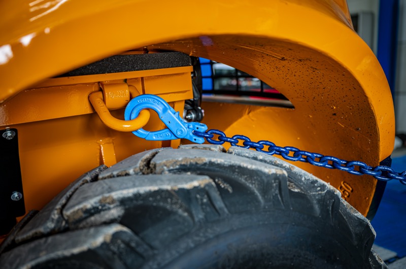 Blauwe sjorketting met haak vastgemaakt aan het sjoroog van een oranje Hangcha ruwterreinheftruck